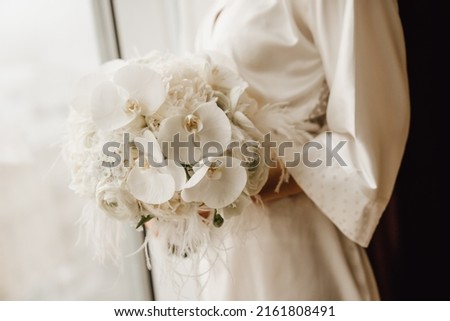 Bride holding wedding white orchid bouquet Royalty-Free Stock Photo #2161808491