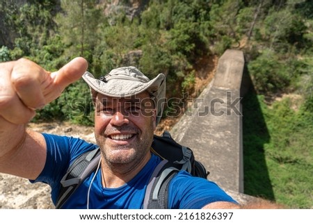 Sweaty hiker takes a selfie on a sunny summer day. 