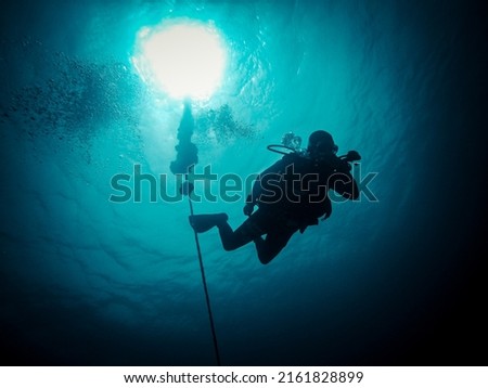 Scuba diver starts descent to depth Royalty-Free Stock Photo #2161828899