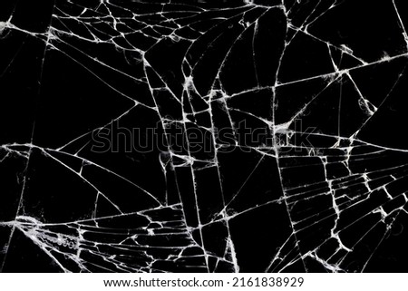 old dirty glass with a lot of cracks, old broken glass on a black background