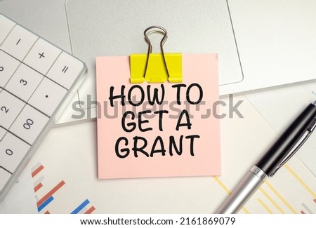 How To Get A Grant write on a sticker isolated on Office Desk