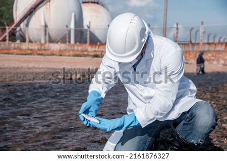 Scientist wearing protective uniform and glove under working water analysis and water quality by get fishes dead to check effected case in laboratory is environment pollution problem concept. Royalty-Free Stock Photo #2161876327