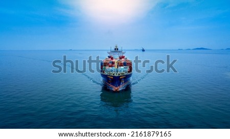 Aerial in front view of cargo ship carrying container and running for export  goods  from  cargo yard port to custom ocean concept technology transportation , customs clearance. Royalty-Free Stock Photo #2161879165