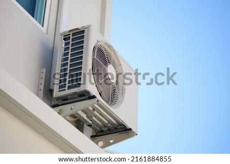 Air condition outdoor unit compressor install outside the house with blue sky Royalty-Free Stock Photo #2161884855