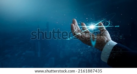 Businessman holding compass of navigate on global economic crisis to resume business growth, Rethink, Reinvent and Recover, Investment,  banking and financial on blue city background. Royalty-Free Stock Photo #2161887435