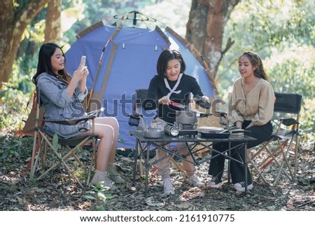 three bestie go camping in the forest and take a photos while cooking