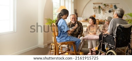 Group of asian senior people listening to young nurse. Psychological support group for elderly and lonely people in a community centre. Group therapy in session sitting in a circle in a nursing home. Royalty-Free Stock Photo #2161915725