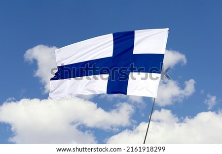 Finland flag is isolated on the blue sky with a clipping path. flag symbols of Finland.