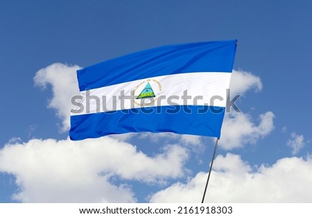 Nicaragua flag is isolated on the blue sky with a clipping path. flag symbols of Nicaragua.
