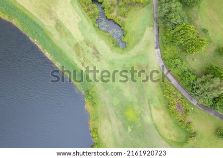Aerial view drone shot of beautiful green golf field fairway and putting green Top down image for sport background and travel nature background Amazing view