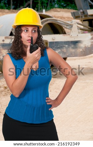 Female construction worker on a job site (photo illustration / image composite) 
