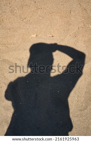 The photographer's shadow on the sandy beach