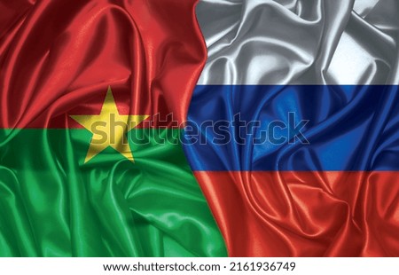 Burkina Faso and Russia two folded silk flags together
