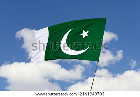 Pakistan flag is isolated on the blue sky with a clipping path. flag symbols of Pakistan.
