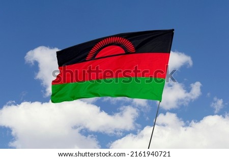 Malawi flag is isolated on the blue sky with a clipping path. flag symbols of Malawi.