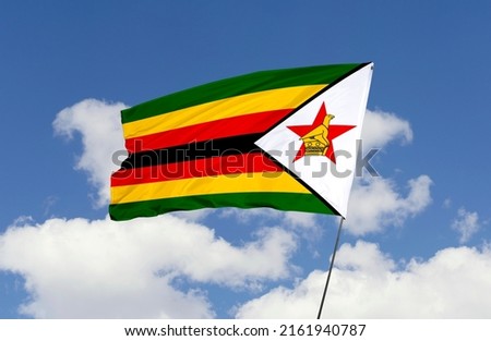 Zimbabwe flag is isolated on the blue sky with a clipping path. flag symbols of Zimbabwe.