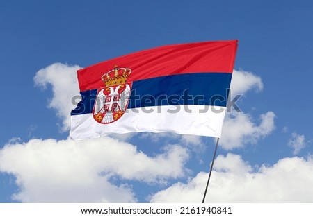 Serbia flag is isolated on the blue sky with a clipping path. flag symbols of Serbia.