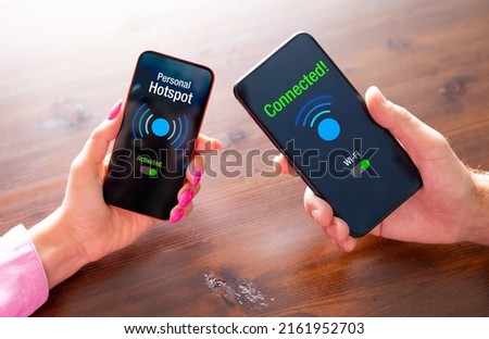 Two persons sharing internet between their phones by using personal hotspot feature Royalty-Free Stock Photo #2161952703