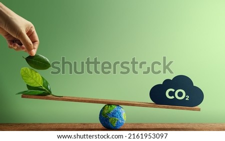 Carbon Neutral and ESG Concepts. Carbon Emission, Clean Energy. Globe Balancing between a Green leaf and CO2. Sustainable Resources, Concern about Environmental. Plant a Tree Sign