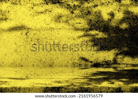 Old Grunge Concrete Table with Leaves Shadow on Wall in Gold Tone.