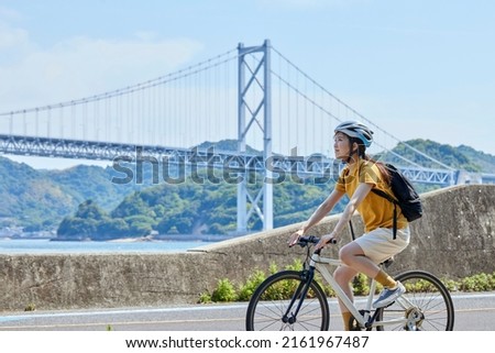 The person who enjoys cycling on the Shimanami Kaido Royalty-Free Stock Photo #2161967487