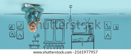 Imaginary world. Funny kid, little boy sitting on the ceiling in drawn room isolated on blue background with pencil sketch. Concept of emotions, ideas, imagination. Upside down