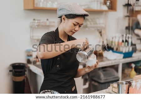 Asian woman barista making coffee with coffee machine. female barista working in coffee cafe. Coffee owner concept. Royalty-Free Stock Photo #2161988677