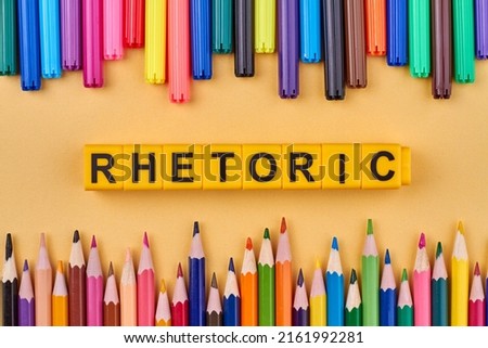 Flat lay composition with colorful pencils and word rhetoric written on yellow cubes. Education concept. Royalty-Free Stock Photo #2161992281