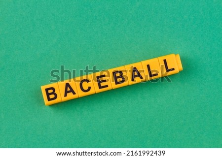 Yellow cubes with inscription baseball on green background. Space for text.