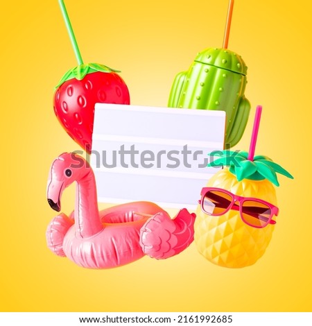 Inflatable flamingo, summer mugs, pink sunglasses and blank lightbox for text on bright background. Creative summer levitation with retro vibe or 80s, nostalgic style, retro aesthetic still life