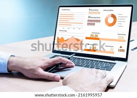 Businessman hand on keyboard laptop with mockup chart presentation slide show on display