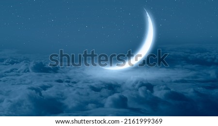 Ramadan Concept - Abstract background with Crescent moon over the sunset clouds