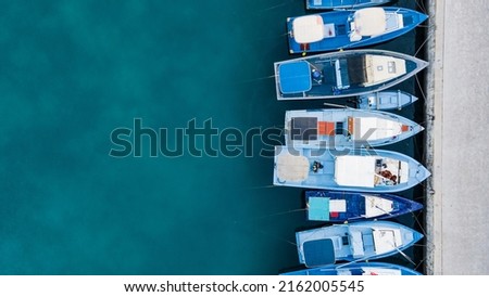 Aerial view of boat at Fuvahmulah Harbour, fishing port and famous dive site for tiger sharks, Fuvahmulah Island South Maldives. Nautical Vessel for marine tourism and scuba diving industry. Royalty-Free Stock Photo #2162005545