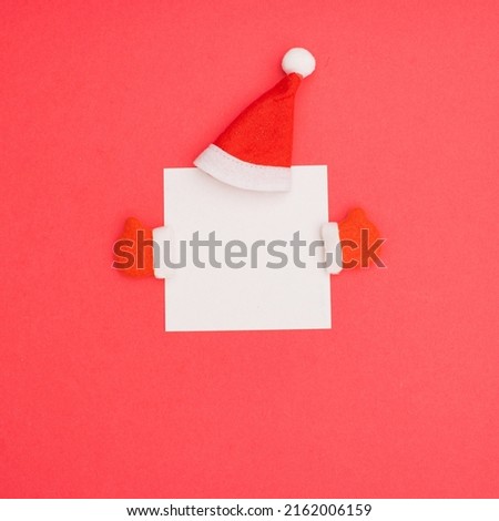 Christmas Square leaflet blank template design idea. Santa Claus red cap and winter gloves against pastel pink background.  Copy space for merry christmas message.