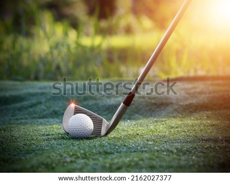 Golf ball close up on tee grass on blurred beautiful landscape of golf background. Concept international sport that rely on precision skills for health relaxation..	