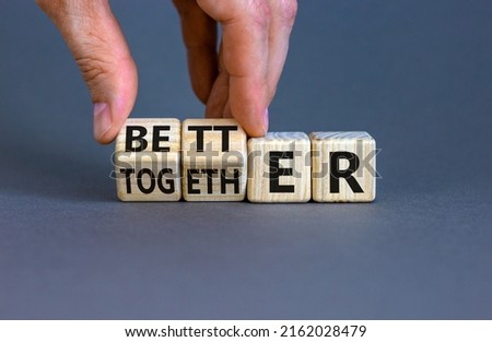 Better together symbol. Businessman turns cubes and changes the word together to better. Beautiful grey table, grey background, copy space. Business, motivational and better together concept. Royalty-Free Stock Photo #2162028479