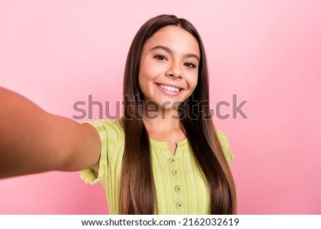 Photo of blogger little lady hold camera take selfie portrait wear green top isolated pink color background