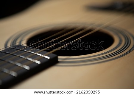 Acoustic guitar strings in close up. Professional musical instrument for guitarist 