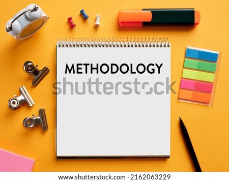 The word methodology written on a notebook on business office desktop. System of methods used in a study or activity concept. Royalty-Free Stock Photo #2162063229