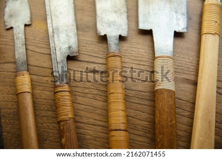 Vintage woodworking saws on a old work table. Well used Japanese Ryoba saws and Dozuki saws on a workbench.  Royalty-Free Stock Photo #2162071455