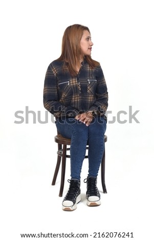 front view of a woman sitting on chair looking away on white background