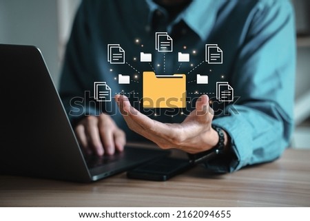 Businessman with Document Management System (DMS) Online Document Database and automated processes in file management Search and manage document database files online. Royalty-Free Stock Photo #2162094655