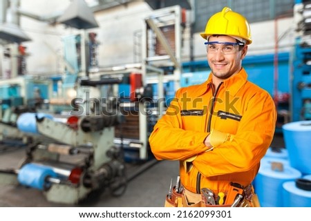 Portrait of happy smiling industrial worer with safety helmet, concept of safety measures, skilled labour and workforce. Royalty-Free Stock Photo #2162099301