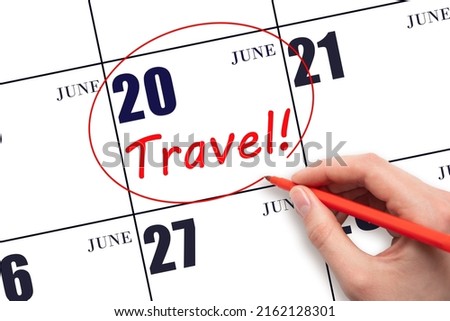 20th day of June. Hand drawing a red circle and writing the text TRAVEL on the calendar date 20 June. Travel planning. Summer month. Day of the year concept.