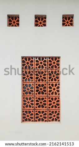 white wall with orange flower pattern