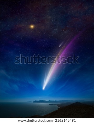 Amazing unreal background: giant colorful comet in starry sky over calm sea and mountains. Comet is icy small Solar System body. Elements of this image furnished by NASA.