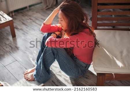 Sad depressed young woman feeling bad down on couch at home. Hopeless alone, upset teen female victim in trouble being heartbroken offended abused, having problem addiction, girl in despair concept Royalty-Free Stock Photo #2162160583