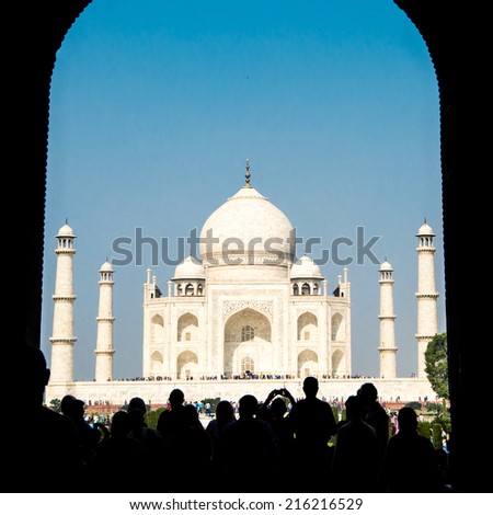 Crowd of tourist entering famous Taj Mahal via gates, Agra, India in bright clear day - architecture background