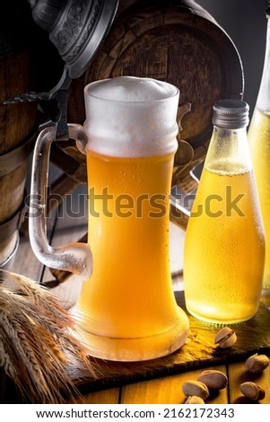Light beer in a glass, on an old background.