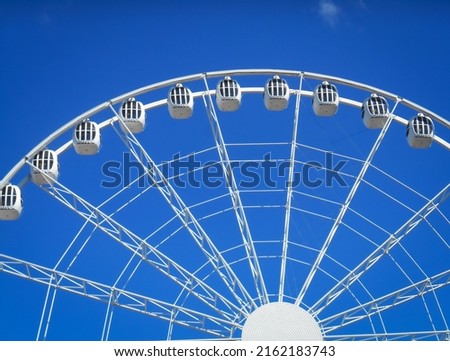 Background with blue sky and part of a ferris wheel, horizontal format
